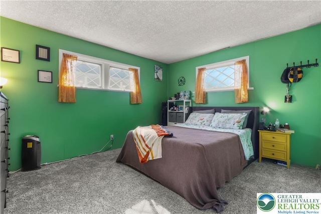 bedroom with carpet floors and a textured ceiling