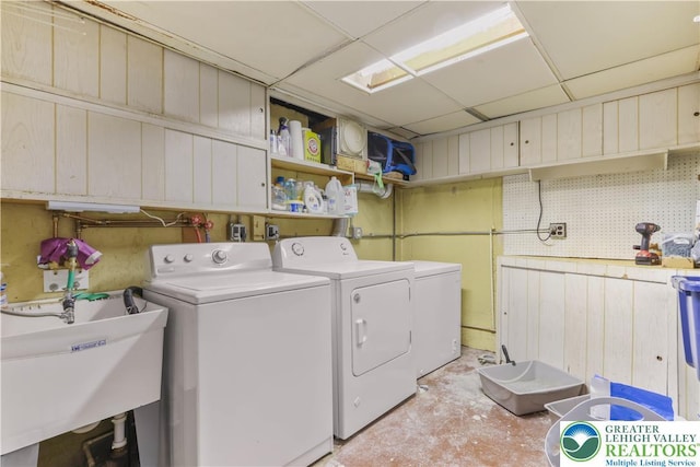 laundry room with a sink, laundry area, and washing machine and clothes dryer