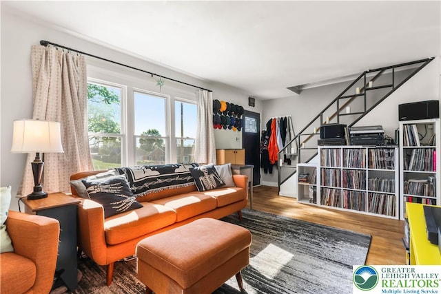 living room featuring stairs and wood finished floors