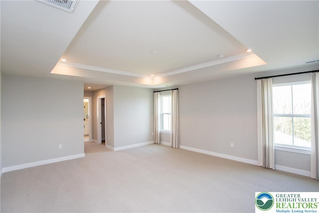 unfurnished room featuring visible vents, crown molding, baseboards, a tray ceiling, and recessed lighting