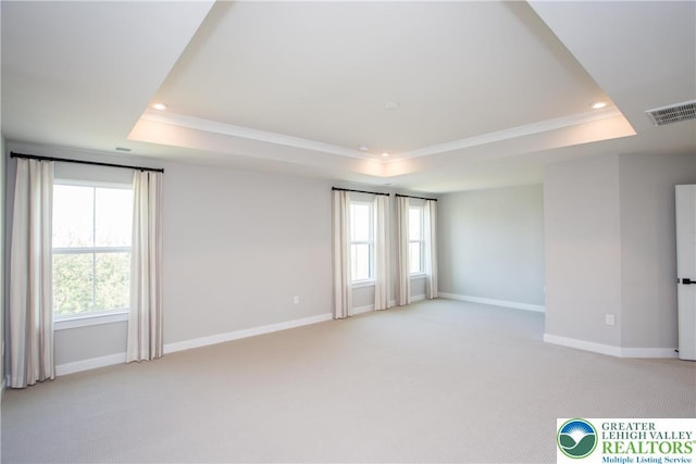empty room with baseboards, a tray ceiling, and recessed lighting