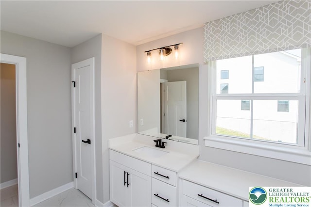 bathroom featuring vanity, marble finish floor, and baseboards