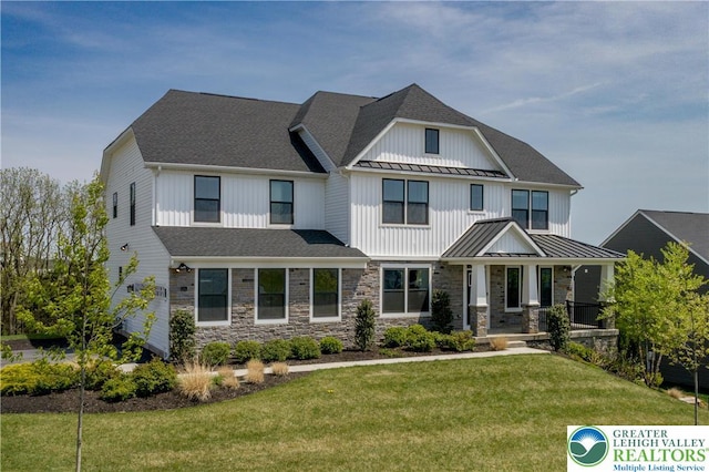 craftsman-style home with a standing seam roof, covered porch, metal roof, and a front yard