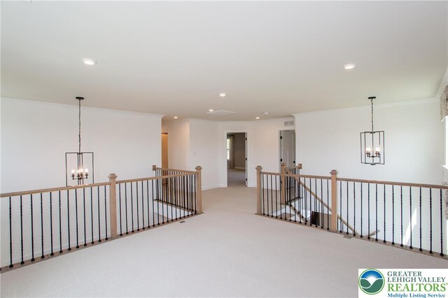interior space featuring carpet floors, recessed lighting, and a notable chandelier