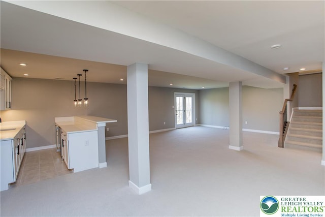 below grade area featuring recessed lighting, baseboards, and light carpet