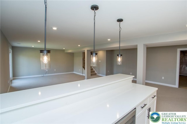 kitchen with light countertops, white cabinetry, baseboards, and recessed lighting