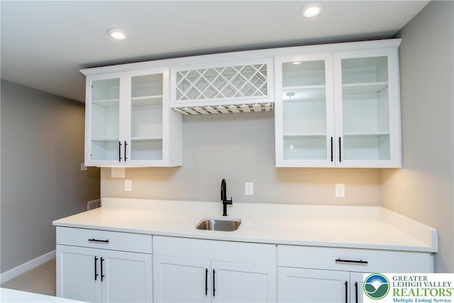 bar featuring recessed lighting, a sink, and bar area