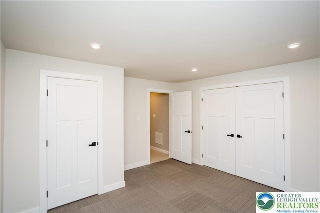 unfurnished bedroom with light colored carpet, recessed lighting, and visible vents