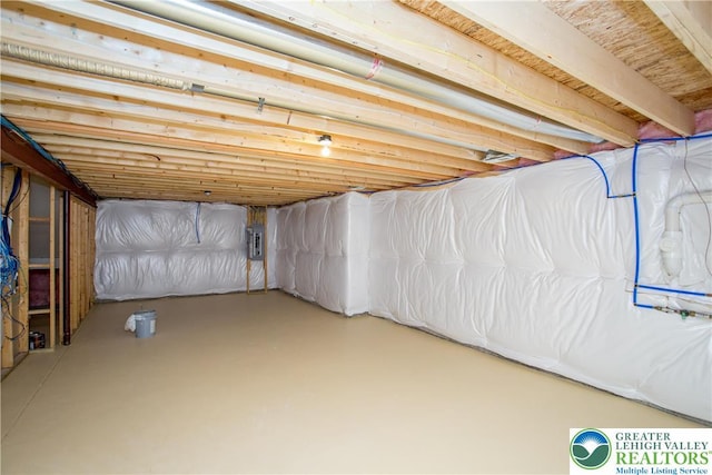 unfinished basement featuring electric panel