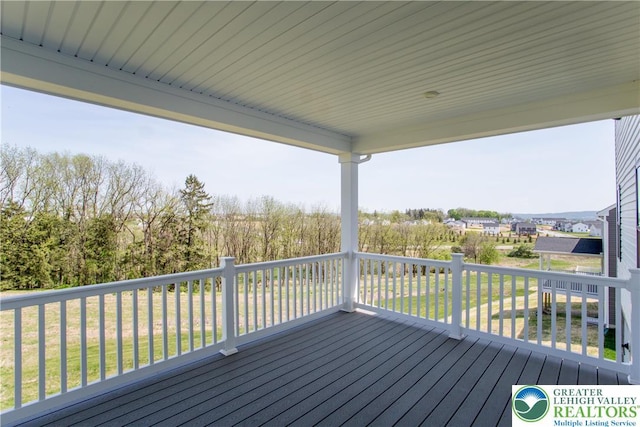 wooden terrace with a yard