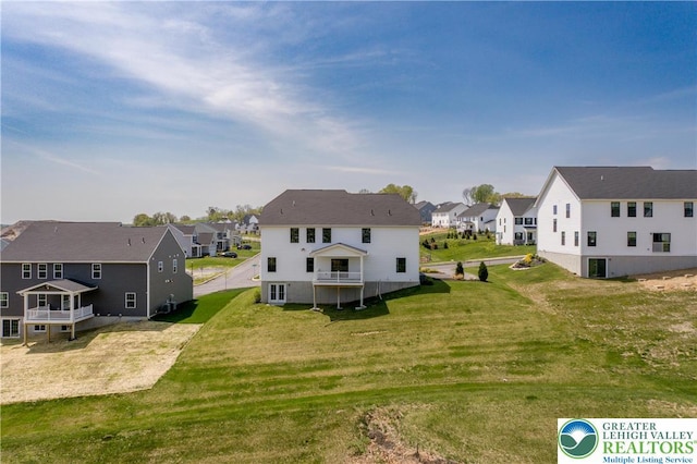 exterior space featuring a residential view, central AC unit, and a lawn