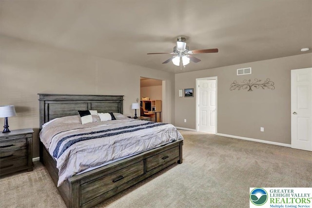bedroom with baseboards, ceiling fan, light colored carpet, and visible vents