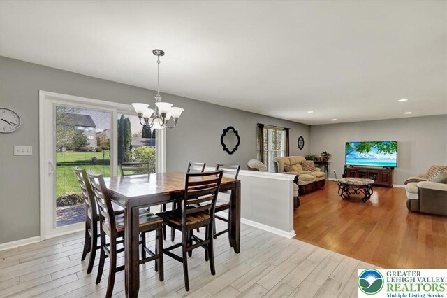 dining area featuring recessed lighting, light wood finished floors, a chandelier, and a wealth of natural light