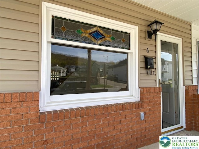 exterior space featuring brick siding