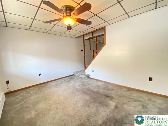 empty room with baseboards, ceiling fan, and carpet flooring