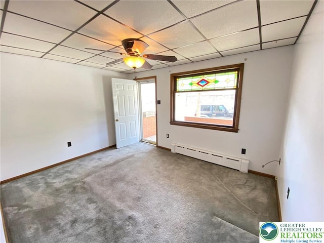 interior space with a baseboard radiator, carpet, and a paneled ceiling