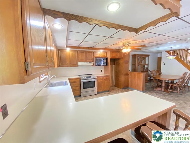 kitchen with stainless steel electric range, black microwave, a sink, light countertops, and under cabinet range hood
