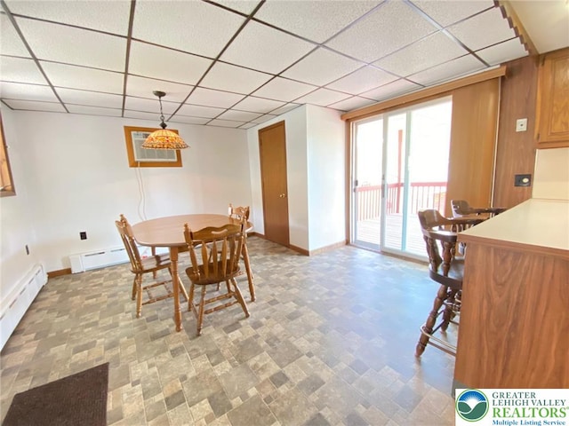 dining area featuring baseboards, a baseboard heating unit, a paneled ceiling, and a baseboard radiator