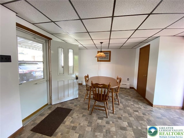 dining area featuring baseboards, a paneled ceiling, and baseboard heating