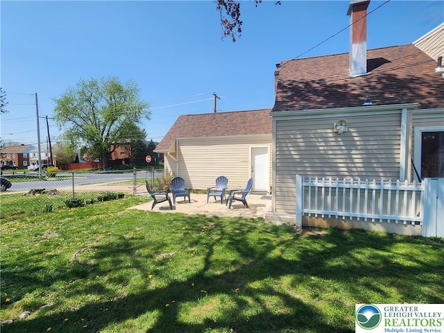 view of yard featuring fence and a patio area