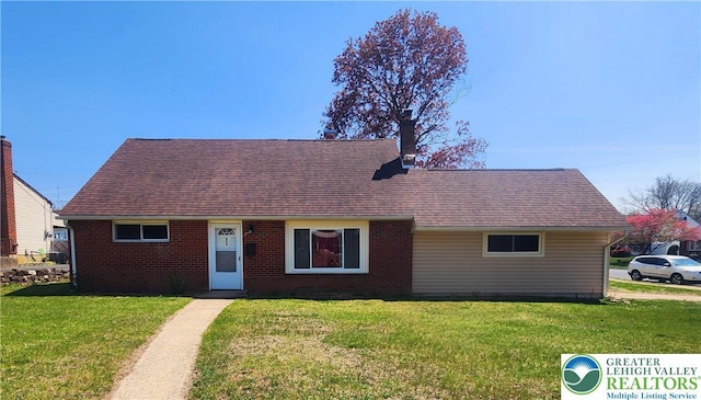 cape cod house with brick siding, roof with shingles, and a front lawn