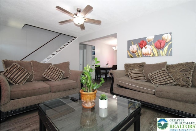 living room featuring ceiling fan, stairs, and wood finished floors