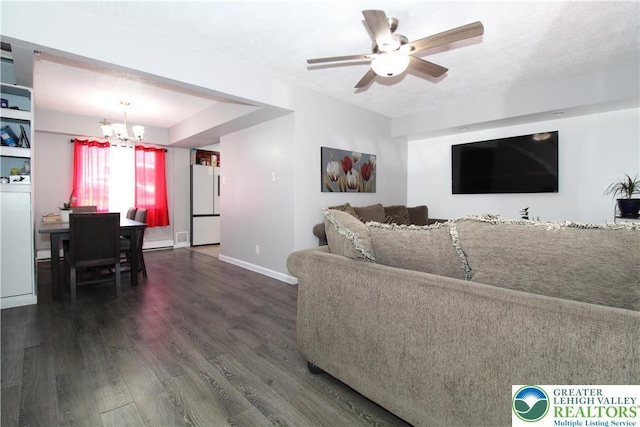 living area featuring baseboards, wood finished floors, and ceiling fan with notable chandelier