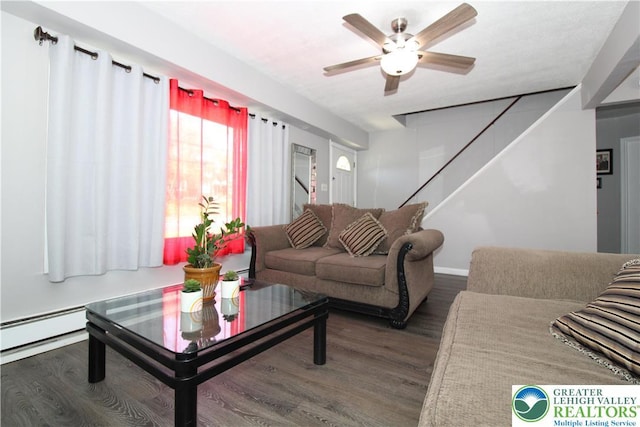living area featuring stairway, baseboards, a ceiling fan, and wood finished floors