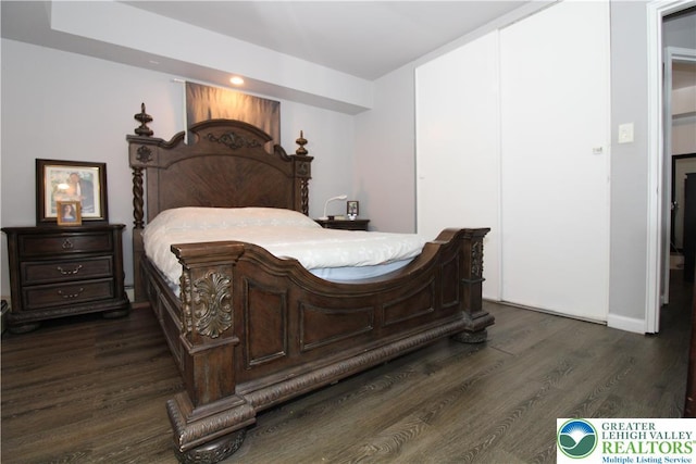 bedroom with recessed lighting, baseboards, and dark wood finished floors