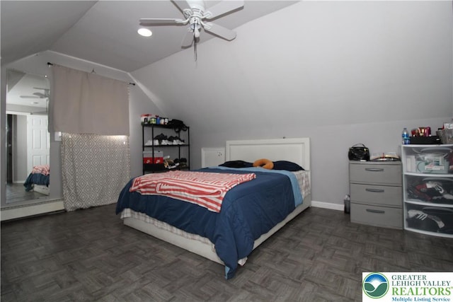bedroom featuring baseboards, ceiling fan, and lofted ceiling