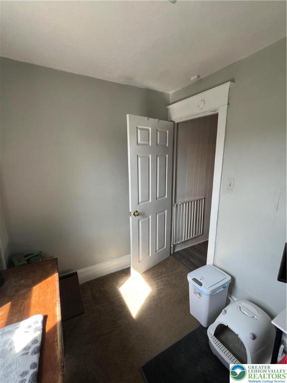 unfurnished bedroom featuring carpet floors and baseboards