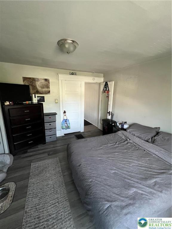 bedroom featuring dark wood-style floors