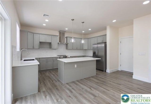 21 Piute Trl, Penn Forest Township, PA 18210 - kitchen featuring stainless steel appliances, gray cabinets, a center island, wall chimney range hood, and a sink