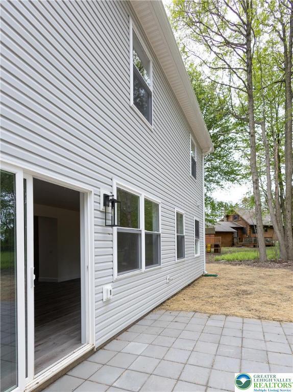 21 Piute Trl, Penn Forest Township, PA 18210 - rear view of property with a patio area