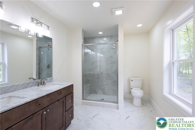21 Piute Trl, Penn Forest Township, PA 18210 - full bathroom featuring toilet, double vanity, recessed lighting, a shower stall, and baseboards
