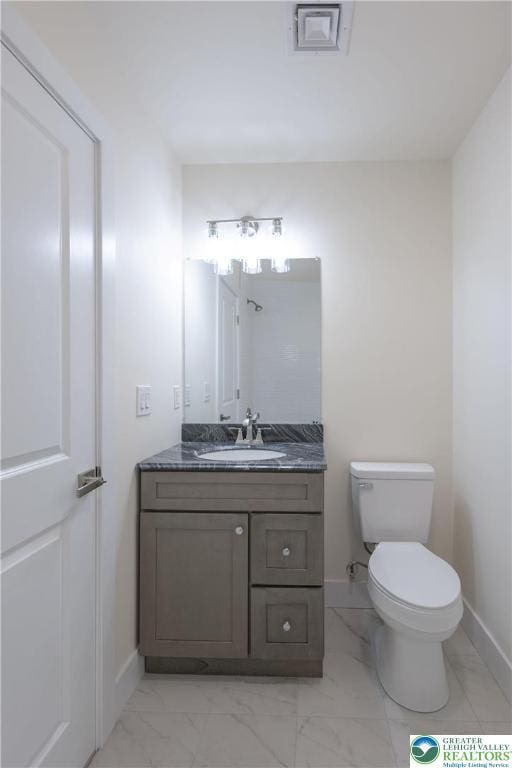 21 Piute Trl, Penn Forest Township, PA 18210 - bathroom featuring baseboards, vanity, toilet, and marble look tiles