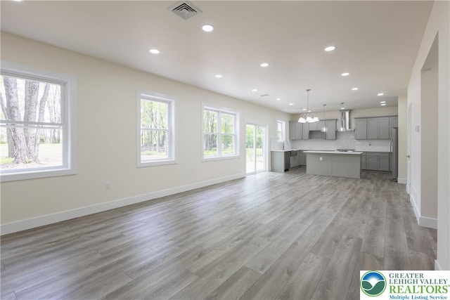 21 Piute Trl, Penn Forest Township, PA 18210 - unfurnished living room with recessed lighting, light wood finished floors, baseboards, and a chandelier