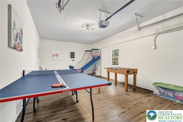 511 Lakeside Dr, Stroud Twp, PA 18301 - recreation room featuring a garage, baseboards, and wood finished floors