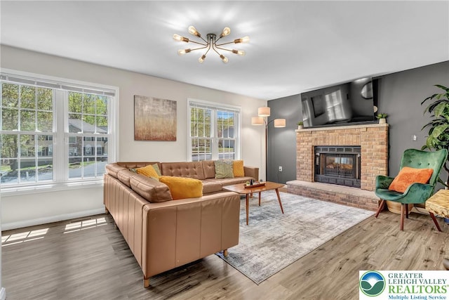 511 Lakeside Dr, Stroud Twp, PA 18301 - living room featuring baseboards, a chandelier, wood finished floors, and a fireplace