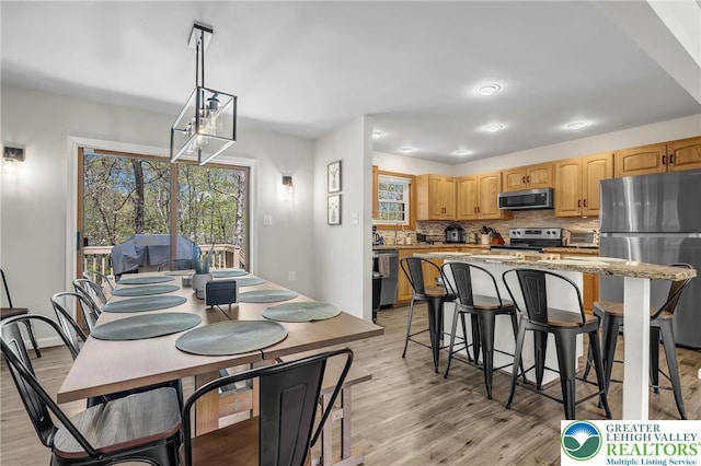 511 Lakeside Dr, Stroud Twp, PA 18301 - dining space with light wood-type flooring and a toaster