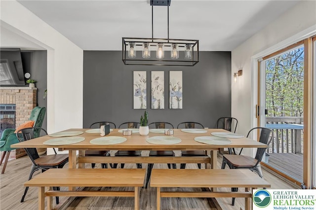 511 Lakeside Dr, Stroud Twp, PA 18301 - dining room featuring light wood finished floors and a fireplace
