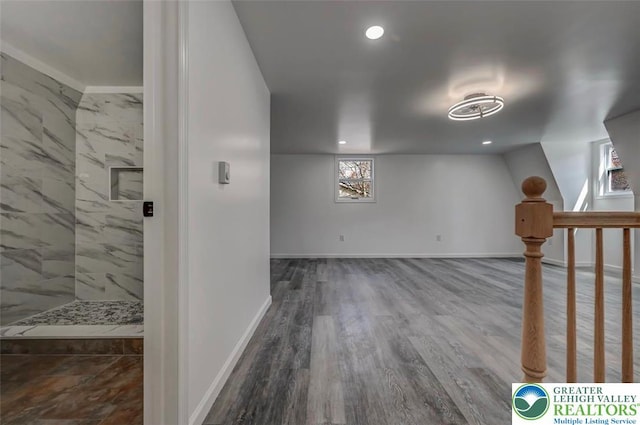 basement featuring recessed lighting, baseboards, plenty of natural light, and wood finished floors