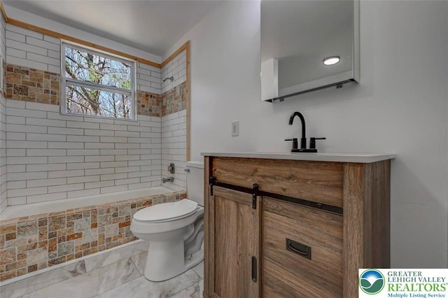 bathroom featuring vanity, toilet, and tub / shower combination