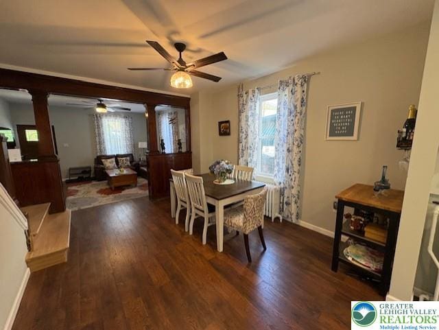 dining room featuring a ceiling fan, baseboards, dark wood finished floors, and a healthy amount of sunlight