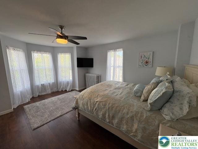 bedroom featuring baseboards, a ceiling fan, and wood finished floors