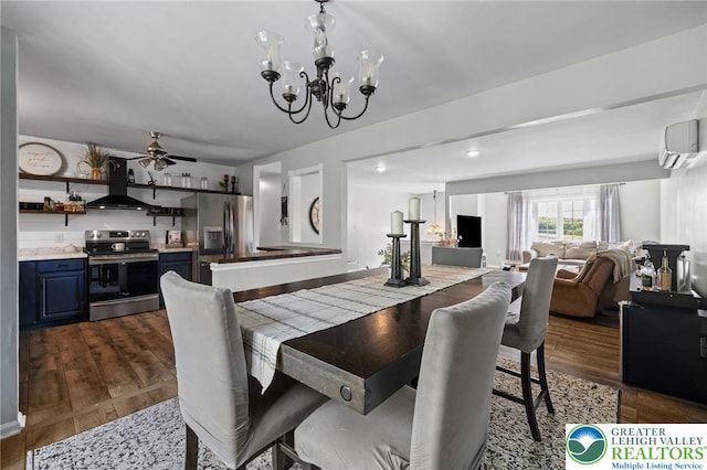 dining room with a wall unit AC, ceiling fan with notable chandelier, and dark wood-type flooring