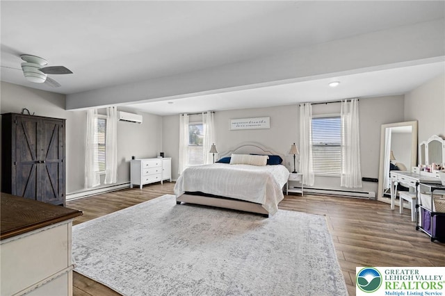 bedroom featuring a wall mounted AC, ceiling fan, baseboard heating, and wood finished floors