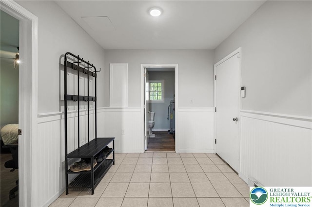 mudroom featuring wainscoting and light tile patterned floors