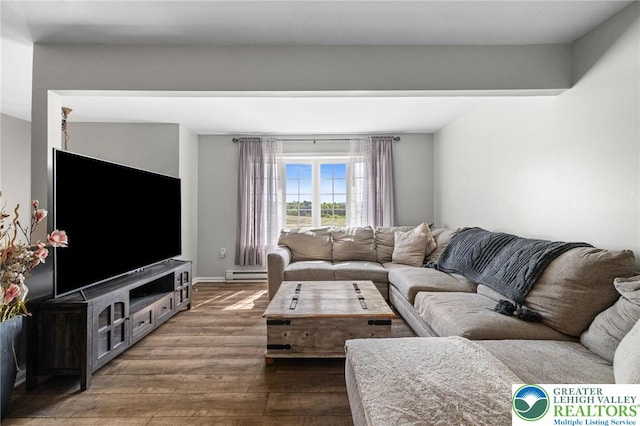 living area featuring a baseboard heating unit and dark wood-style floors
