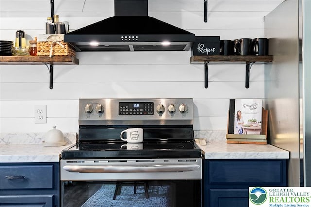 kitchen with wood finished floors, stainless steel appliances, island exhaust hood, and blue cabinets